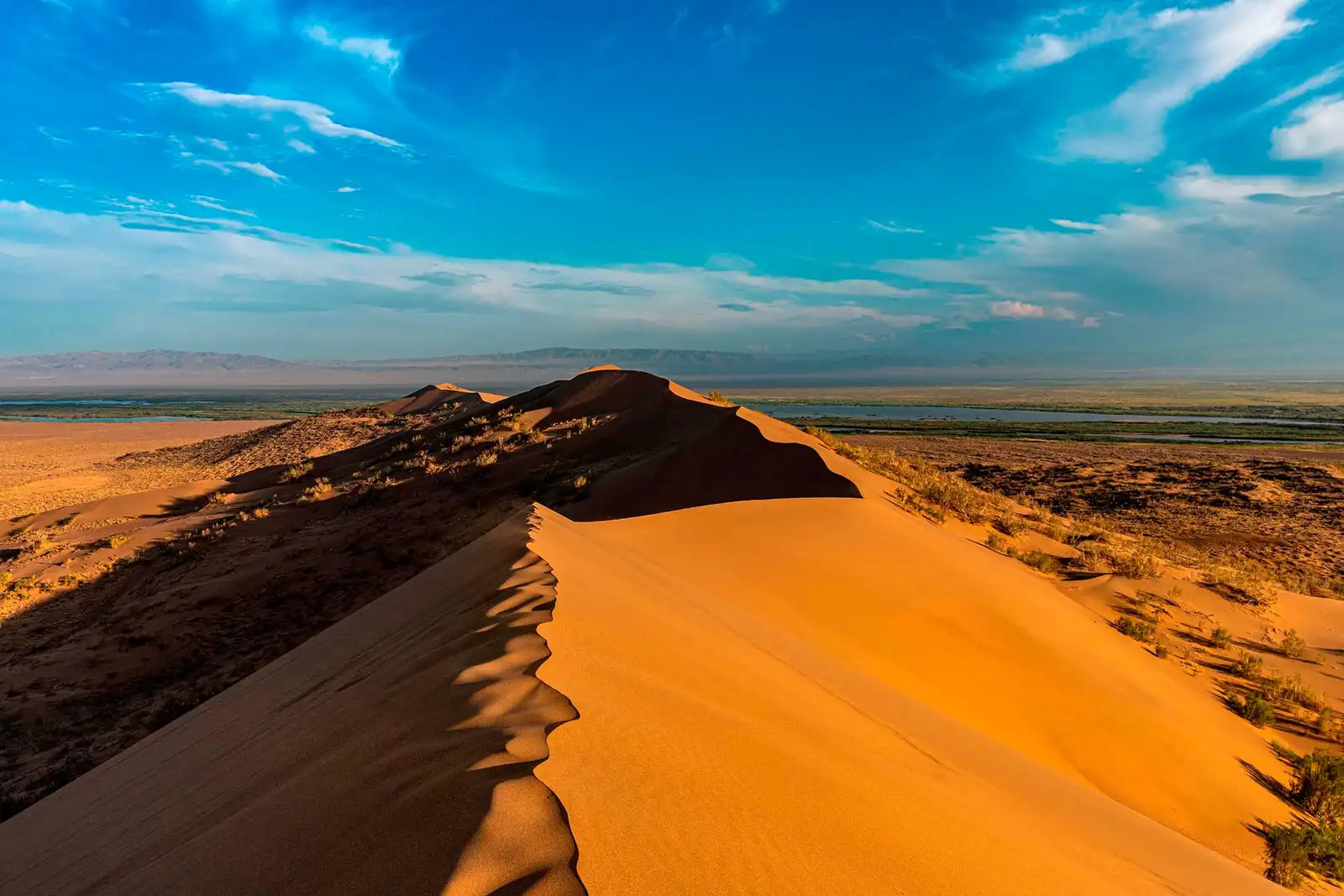 The Singing Dune ridge in Altyn Emel with the Ili River valley visible below